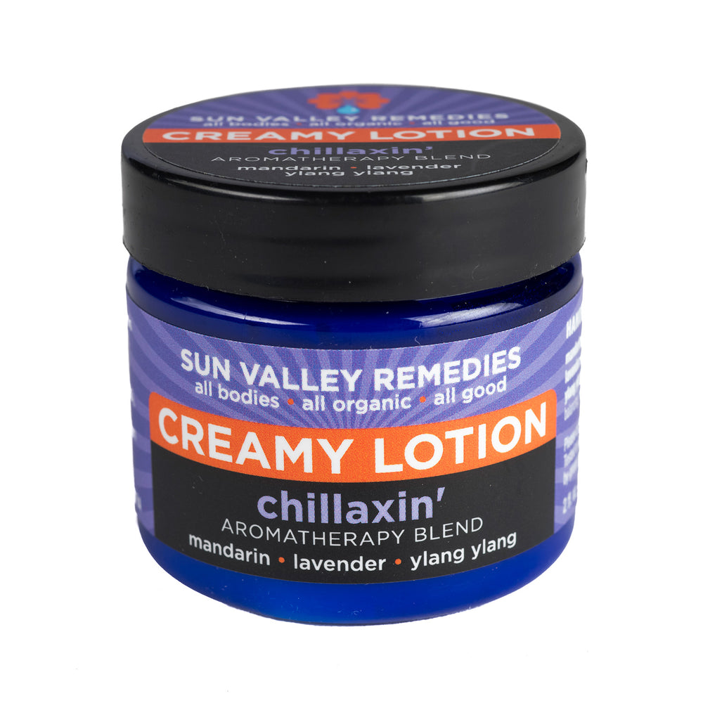 Two ounce Cobalt jar of Chillaxin' Creamy Lotion. The label indicates the aromatherapy is mandarin, lavender, and ylang ylang