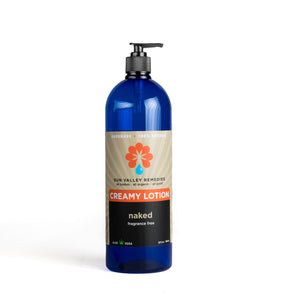 Thirty two ounce cobalt bottle of Naked Creamy Lotion. The label indicates this is fragrance free and made with Aloe Vera.