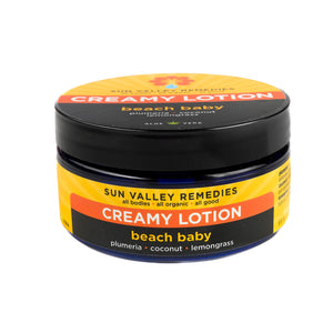 Nice ounce cobalt jar of Beach Baby Creamy Lotion. The label indicates the aromatherapy is plumeria, coconut, and lemongrass