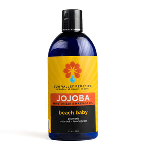 Nice ounce Cobalt bottle of Beach Baby Jojoba oil.  The label indicates the aromatherapy is plumeria, coconut, and lemongrass