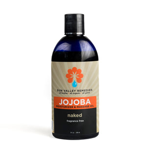 Nine ounce cobalt blue bottle of Naked Jojoba oil. The label indicates this is a fragrance free body oil and moisturizer