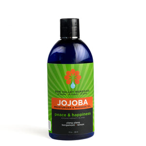 Nine ounce cobalt bottle of Peace and Happiness Jojoba oil. The label indicates the aromatherapy is ylang ylang, bergamot, lemon