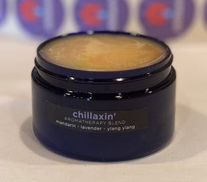 Four ounce cobalt jar of Chillaxin' Himalayan Salt Scrub. The label indicates aromatherapy of mandarin, lavender, ylang ylang