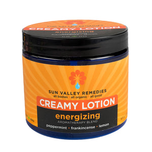 Sixteen ounce cobalt bottle of Energizing lotion. The label indicates the aromatherapy is peppermint, frankincense, and lemon