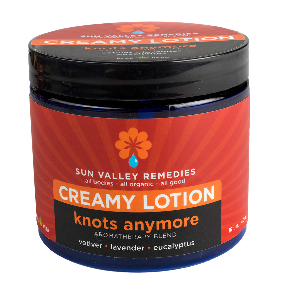 
            
                Load image into Gallery viewer, Sixteen ounce cobalt blue jar of Knots Anymore lotion. The label indicates the aromatherapy is vetiver, lavender, eucalyptus
            
        