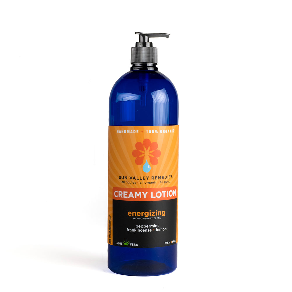Thirty two ounce cobalt bottle of Energizing lotion. The label indicates the aromatherapy is peppermint, frankincense, lemon