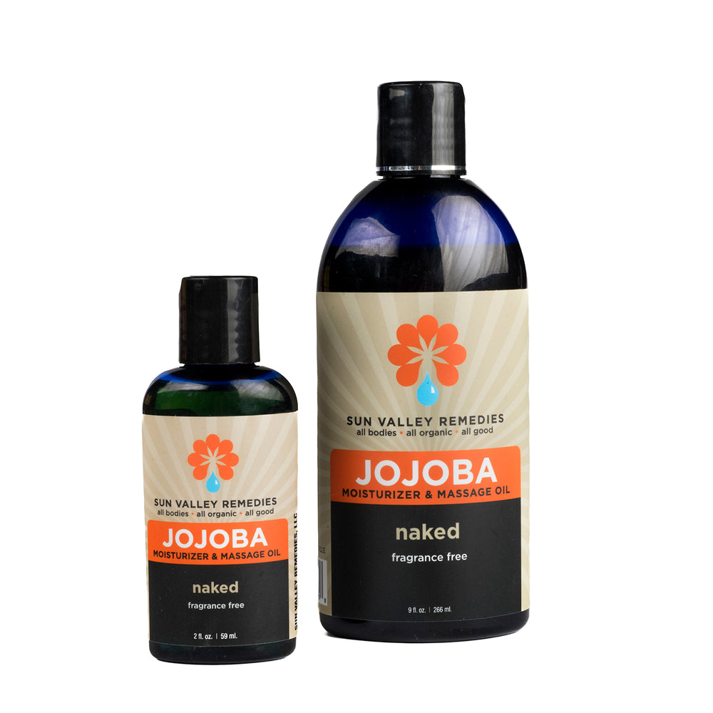 
            
                Load image into Gallery viewer, Two cobalt bottles of Naked Jojoba Oil. The tan label indicates that this is a fragrance free body oil and moisturizer
            
        